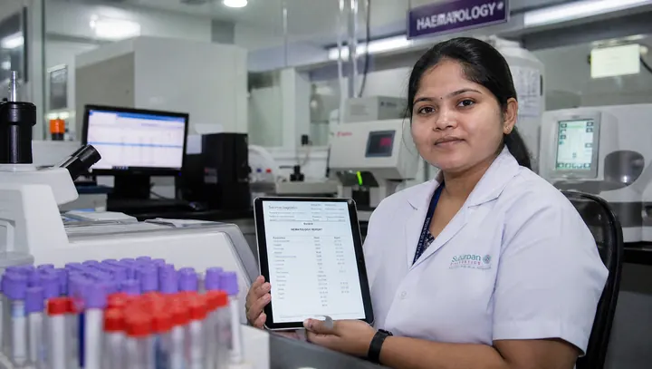 Lab technician reviewing digitized pathology reports on a tablet